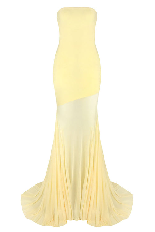 Yellow strapless gown with a gradient effect on a white background