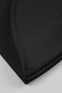 Chaqueta negra con escote en V profundo y falda lápiz con tiras
